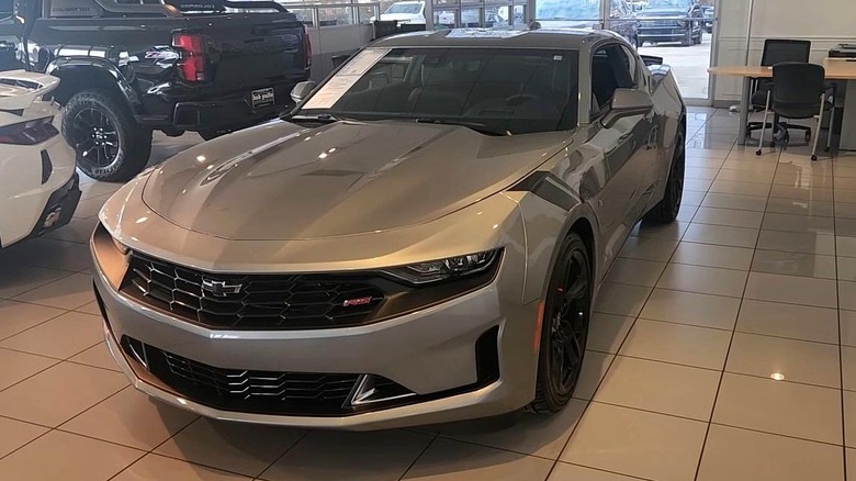 Front 3/4 static shot of a 2024 Chevrolet Camaro 3LT RS Coupe with other cars in the background