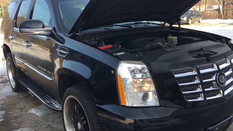 A Black Escalade with the hood open