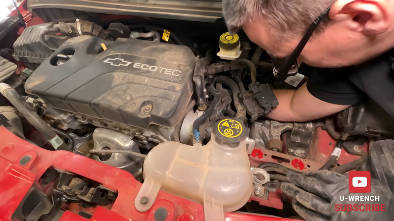 Mechanic replacing a 2015 Chevy Spark's transmission