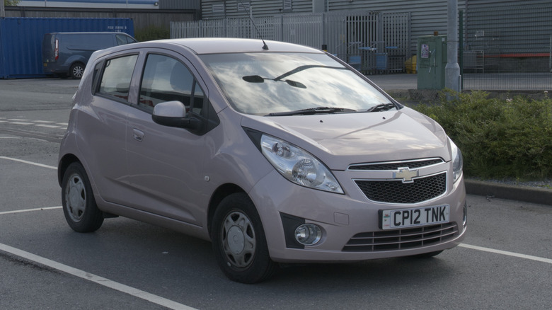 A beige 2015 Chevy Spark in a parking lot