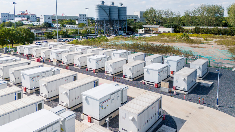 Overhead view of a battery storage facility with buildings in the distance