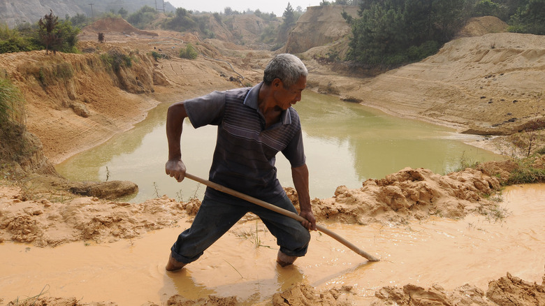 A labourer works at the site of a rare earth metals mine at Nancheng county, Jiangxi province, China