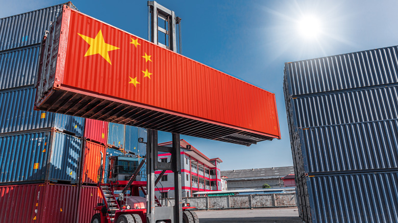 Shipping container with China flag superimposed over it