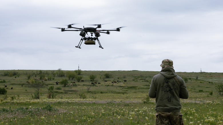 A soldier flies a drone