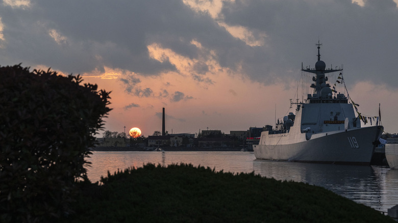 PLA Navys missile destroyer Guiyang pulls into port at sunset