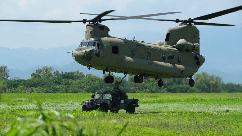 Chinook helecopter assisting army troops on ground