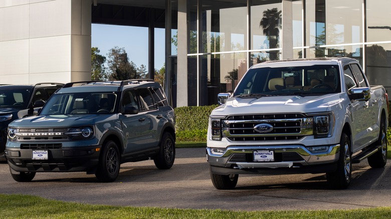 blue SUV next to white truck