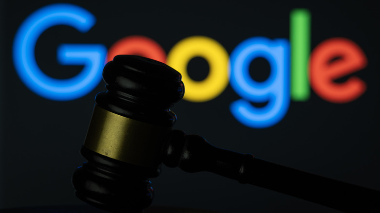 A judge's gavel with the Google logo in the background