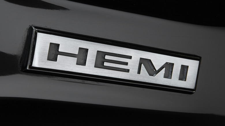 A close-up shot of a HEMI badge on a black 1968 Dodge Charger