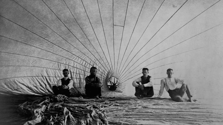 men inside an observation balloon