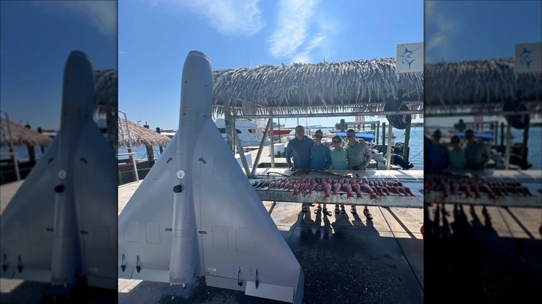 A fishing charter's customers and their catch beside a LUCAS drone