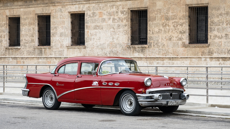 A 1956 Buick Special waiting for a taxi fare in havana.