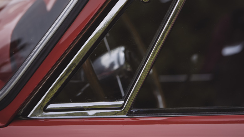 small vent window on red car door