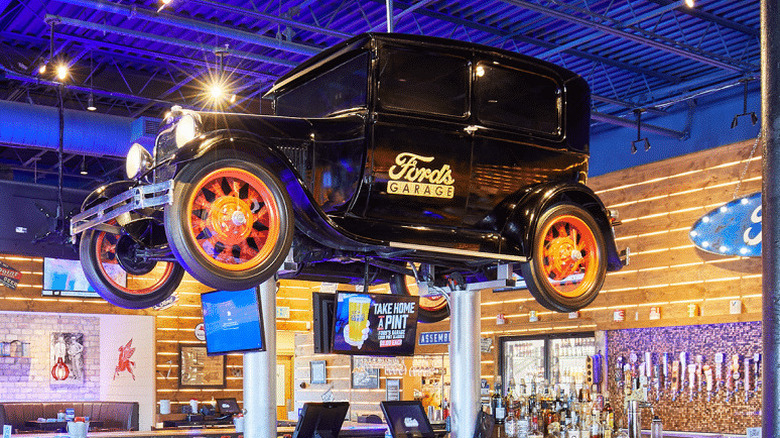 ford's garage interior with classic car hanging