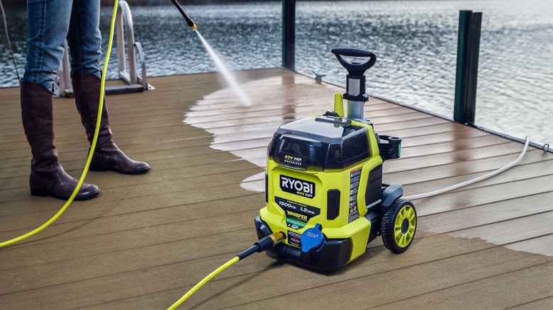 Person using Ryobi pressure washer