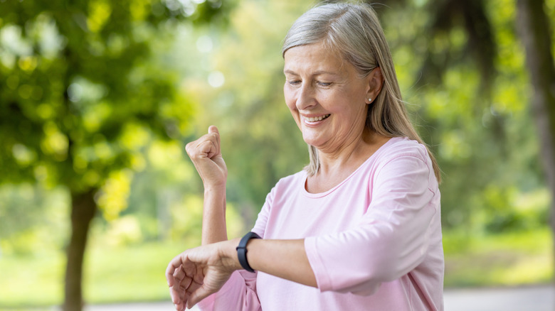 Elderly women looking at her smartwatch