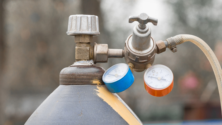 Close-up of a CO2 cylinder with gearbox industrial gas bottle system.