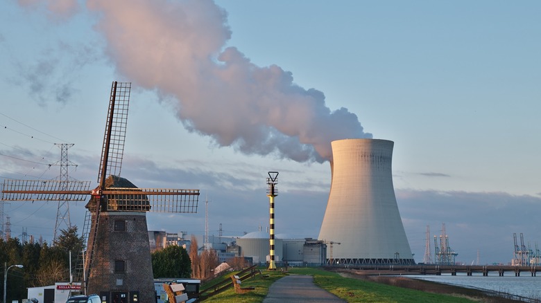 A windmill in front of a nuclear power plant in Doel, Belgium