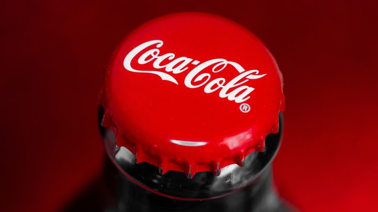 Close-up of the Coca-Cola logo on a bottlecap.