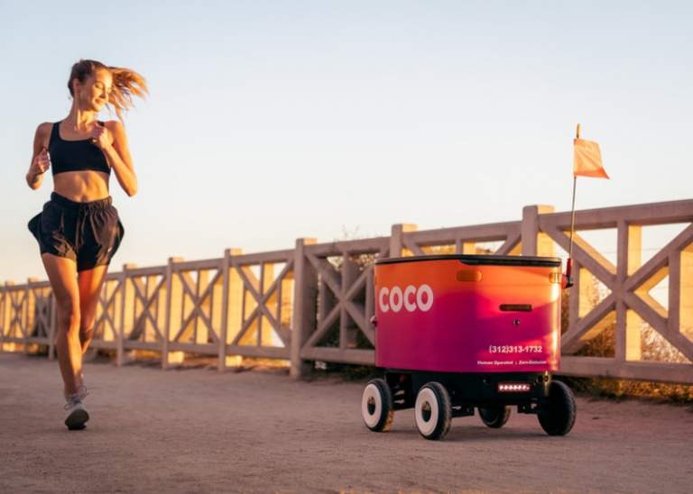 Woman running alongside robot