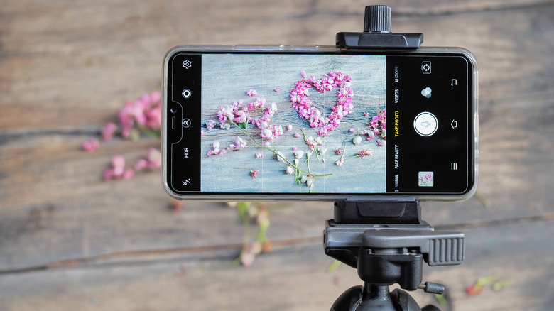 A smartphone supported by a tripod
