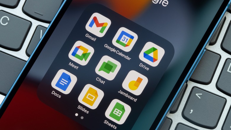 Google applications on a smartphone in front of a keyboard