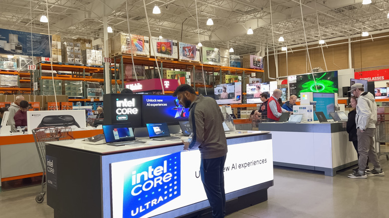 Shoppers looking at laptops in Costco