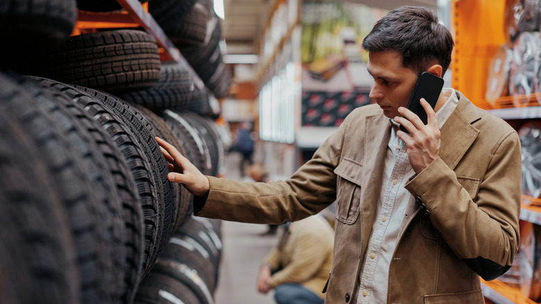 A person on the phone choosing tires at a tire store