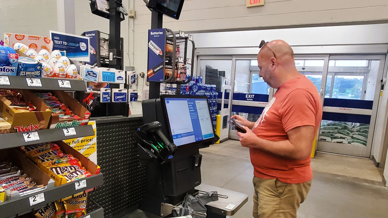 Man at self-checkout at Lowe's store