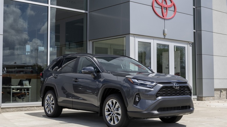 A RAV4 in front of the Toyota dealership