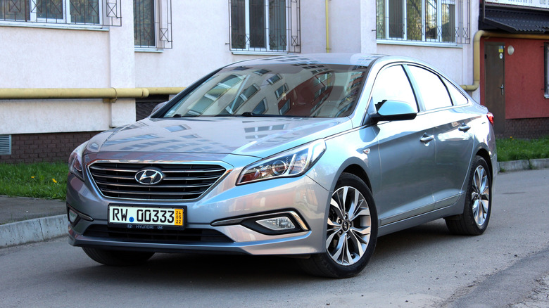 A silver 2015 Hyundai Sonata parked on a street