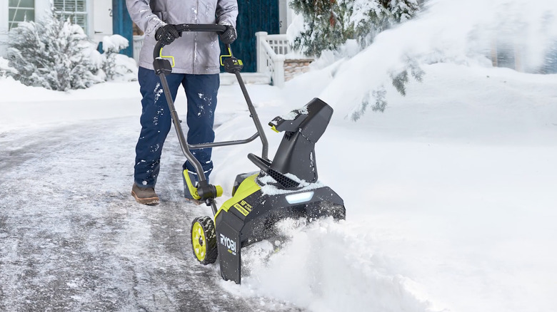 Person clearing snow with Ryobi snowblower