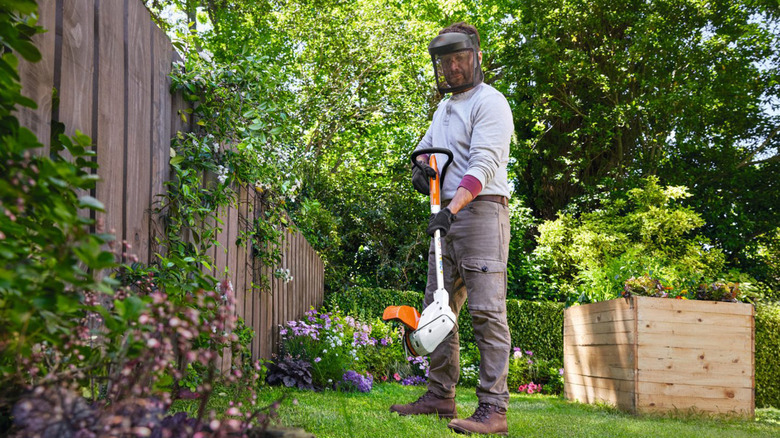 A man using a Stihl weed whacker.