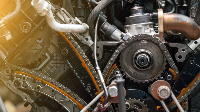 Inside a car engine with view of timing chain and tensioners