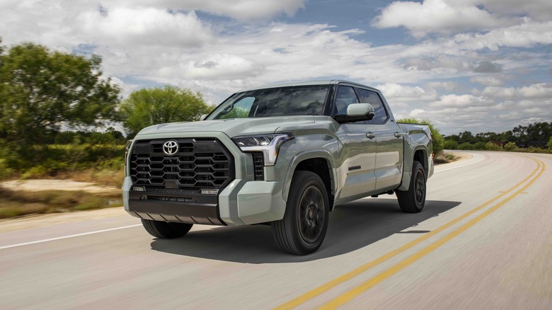 Grey Toyota Tundra driving down a country front 3/4 dynamic shot.