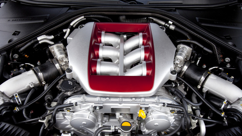A close-up of a Nissan V6 engine top.