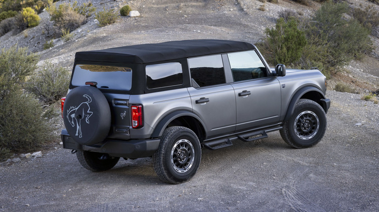 2025 Ford Bronco parked on rocks, rear-right 3/4 view