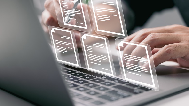 man opening document icons on laptop