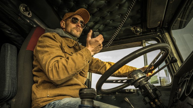 Driver wearing sunglasses uses CB radio