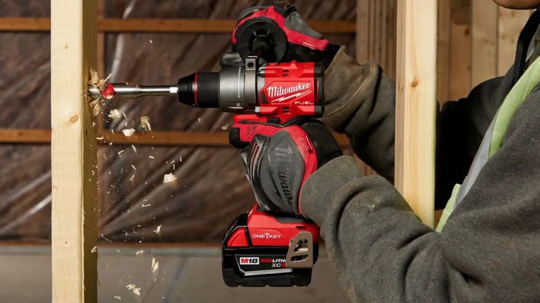 A person drilling into wood with a Milwaukee M18 Fuel Drill/Driver
