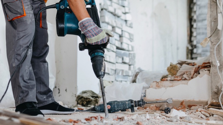 Using a hammer drill to drill a hole in concrete.
