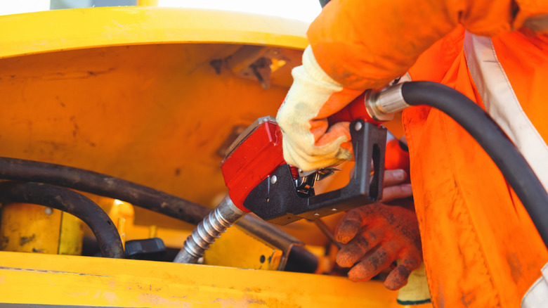 Person refueling a diesel engine