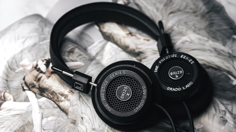 Grado SR125x headphones on a pale textured cloth surface
