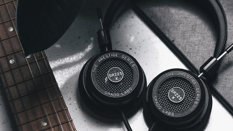 Close-up of the Grado S5225x headphones set down next to the neck of an electric guitar