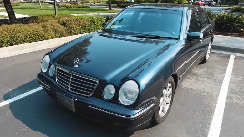 A black 2000 Mercedes-Benz E-320 parked in a lot.