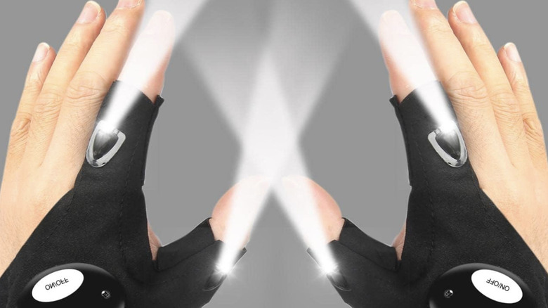 Hands wearing the Moipejo LED flashlight gloves with lights on