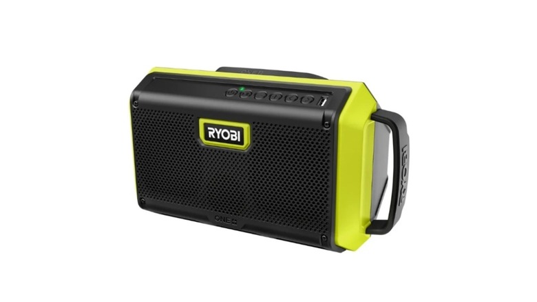 Green and black Ryobi brand speaker with handle on white background