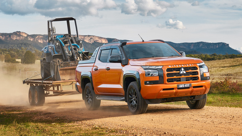 2024 Orange Mitsubishi Triton towing