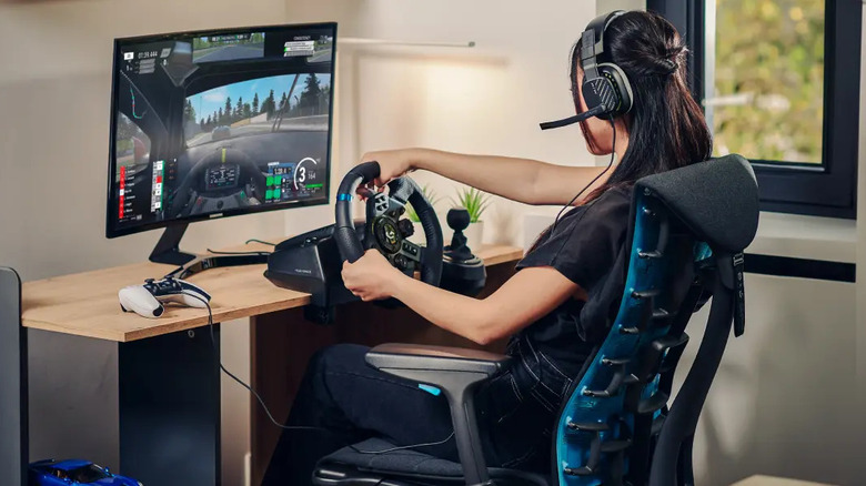 woman gaming with steering wheel