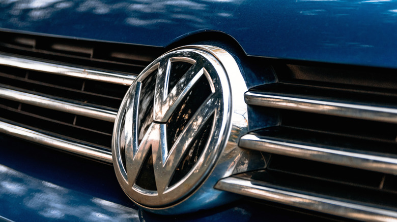Close-up of a Volkswagen logo on the grille of a blue vehicle